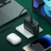 LDNIO Q367 fast charger on desk charging laptop, phone and earbuds with multiple ports and compact black design