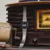Casio Vintage Watch draped over retro radio with digital display active, creating nostalgic modern-classic contrast.