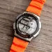Casio AE-1000W-4BVDF Youth World Time Digital Chain Watch worn on wrist with orange band and digital display