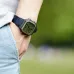 Wrist view of Casio AE-1200WHB-1BVDF Digital Watch with black strap showing time and circular sub-display outdoors.