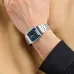 Wrist view of Casio AQ-230A-1DMQ Watch with black dial, silver markers, and small digital display on tan fabric surface.