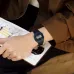 Wrist view of Casio F-91W-1DG Watch with black strap and blue bezel resting on sketchbook with ink drawings.