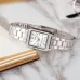 Top view of Casio LTP-V007D-7EUDF Ladies Chain Watch resting on notebook with gold-edged pages.