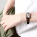 Close-up wrist view of Casio LTP-V007L-9EUDF Ladies Watch with brown strap and silver case on green fabric.