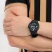 Lifestyle wrist view of Casio MRW-200H-1B2VDF Analog Watch with black strap worn with striped shirt outfit.
