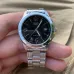 Handheld view of Casio MTP-1215A-1ADF Analog Watch with black dial, gold markers, and silver band.