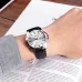 Wrist view of Casio MTP-V004D-7AUDF Watch with silver dial, black markers, and leather strap resting on magazine.