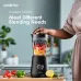 A front‑facing kitchen view of the Oraimo SmartBlender Sleek OH-B2N 1.5L Blender blending colorful ingredients as a hand secures the lid for operation.