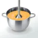 Close‑up view of the Panasonic MX‑GS1 Hand Blender blending soup inside a metal pot with an immersion shaft.