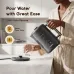 Front view of Oraimo FastBrew Electric Kettle with digital display as user pours water into glass on countertop.
