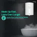 Bathroom view of Havells Monza NU Geyser showing wall-mounted unit beside steaming bathtub and shower fixture.