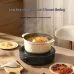 Close-up of Xiaomi Mijia S1 Induction Cooker simmering soup in ceramic pot with noodles, dates, and goji berries at 65°C.