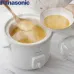 Top cooking view of the Panasonic NF‑N51A 5L Slow Cooker showing soup being poured into bowls from the ceramic pot.
