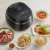 Kitchen countertop view of the Panasonic SR‑DM104 1L Rice Cooker placed beside prepared dishes and serving plates.