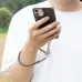 Close-up of a hand holding a phone, secured by the black lanyard and metal clip connected to the charging port.