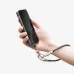 Close-up of a person holding a smartphone, which is secured by the black lanyard wrist strap connected to its bottom port.