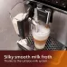 Front view of Philips EP4346/70 4300 Series Coffee Machine dispensing layered coffee and milk froth using LatteGo system.