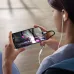 A person watches a video on a smartphone using the BWOO BZ-48 Lightning adapter to connect to wired earbuds.