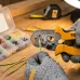Wrist view of Tolsen 38058 Crimping Plier with gloves crimping yellow terminal onto green and yellow wire.