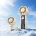 Lifestyle view of Hoco HX602 portable handheld fan displayed on a snowy outdoor surface.