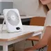 Lifestyle view of Hoco HX607 slim desktop fan placed on a desk beside a user.