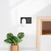 LDNIO Y2 LED night light plugged into wall socket in modern room setup with plant and wooden cabinet background