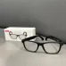 Front view of XO E12 smart audio sunglasses with rectangular frame design beside retail packaging.