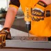 Action view of INGCO CDLI122061 Cordless Drill in use on metal surface with protective gloves and vertical drilling motion.