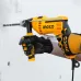 Action view of INGCO ID8108 Drill Machine drilling into wall with side handle, worn gloves, and visible INGCO branding.