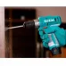 Action profile view of a gloved hand operating the TOTAL 20Nm Cordless Drill Machine to drill into a surface.