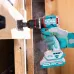 Close-up of TOTAL TIDLI206681 Drill Machine boring a hole in wood with hole saw bit and visible wood dust spray.