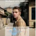 Lifestyle portrait view of Unikyy MAX 60 ANC earbuds worn outdoors highlighting intelligent noise reduction in real world use