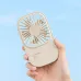 Front view of the Jisulife Life 9 S Chrome Mini Handheld Fan showing a compact gold grille design held in hand against a blue background