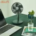 Lifestyle desk setup view of the Jisulife FA13P Portable Desk Fan beside a laptop and plant showing compact tabletop cooling design
