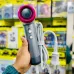 Handheld view of Awei DS-2 Hair Dryer with metallic gray body and pink nozzle, wrapped cord, and control buttons.