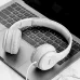Top-down view of the white Hoco W21 Graceful Charm Wired Headphone resting on a laptop keyboard