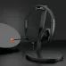 Desk setup view of the Meetion MT‑HP003 3.5mm Wired Headphone placed on a stand beside accessories on a dark surface.