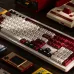 Retro gaming view of 8BitDo Retro 108 Keyboard styled like Famicom with red, white, and gray keycaps among vintage consoles.