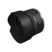 Angled view of compact Canon RF 16mm f/2.8 STM ultra-wide prime lens fitted with attached petal-style lens hood