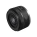 Angled view of compact Canon RF 50mm f/1.8 STM prime lens displaying front glass element and Focus/Control switch