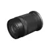 Angled view of compact Canon RF-S 55-210mm f/5-7.1 IS STM zoom lens displaying front glass element and control ring