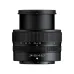 Front profile view of extended Nikon NIKKOR Z 24-50mm f/4-6.3 zoom lens standing vertically showing focal length markings