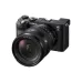 Angled front view of Sony FE 20-70mm f/4 G zoom lens mounted on a compact black Sony Alpha 7C camera body