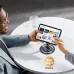 Adjustable desk tablet stand with 360 degree rotating base, user browsing on tablet comfortably at table