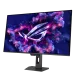 An angled front view of the black ASUS ROG Strix OLED XG32UCDS monitor on its stand, displaying a purple/pink ROG logo and glowing particles on the screen.
