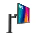 A profile view of the black BenQ DesignVue PD2706UA designer monitor on a black arm stand, displaying abstract colors.
