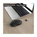 Desk setup view of the AULA AM205 2.4G Wireless Mouse placed beside a laptop showing plug‑and‑play nano receiver usage.