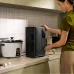 A person uses the EcoFlow Delta 3 Air 2000 Portable Power Station on a kitchen counter to power an appliance.
