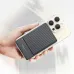 Awei 130120 portable magnetic power bank held in hand, compact size with textured surface and wireless charging support