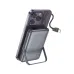 Person holding a dark metallic gray Hoco Q43 10000mAh Power Bank, showing the built-in USB-C cable and stand.